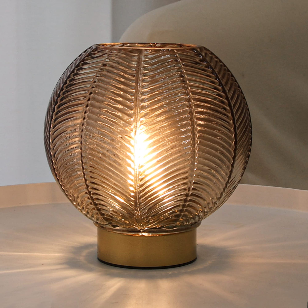 LUSHARBOR amber-glass table lamp provides portable ambience on any surface.