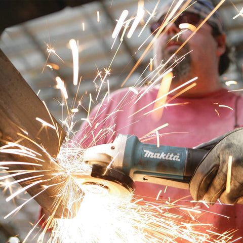 Spindle lock on Makita 9557PB enables quick wheel changes.