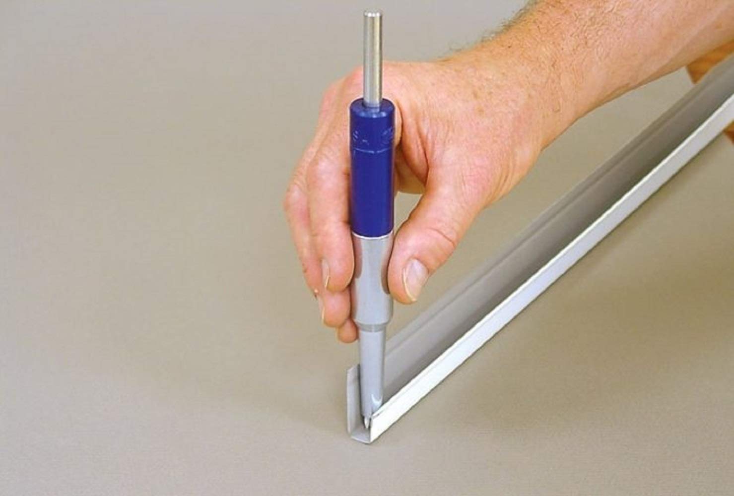 Blue Malco TNP2S heavy duty trim nail punch in action for soffit and fascia installation.