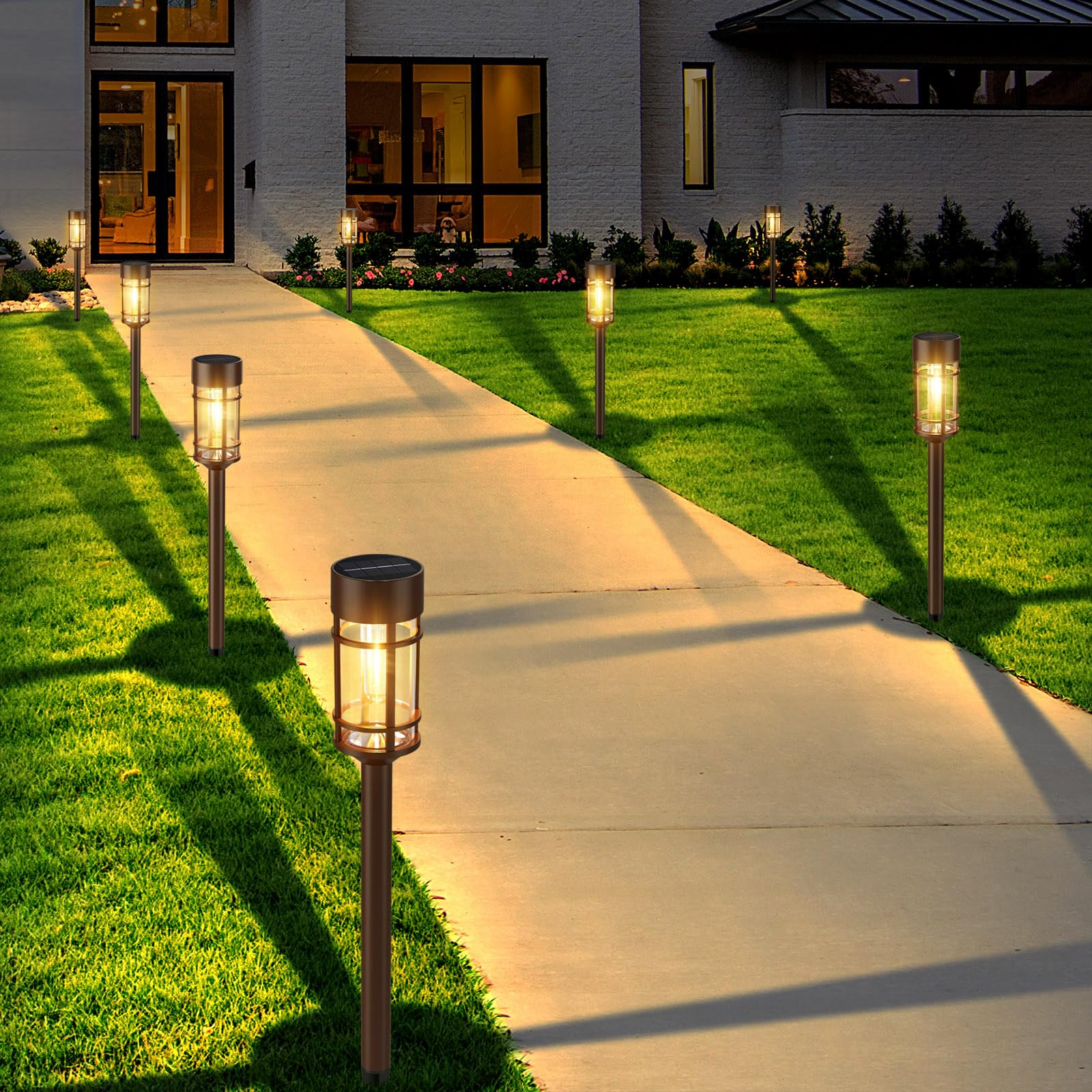 Mancra solar light stake with stainless steel pole along a lawn