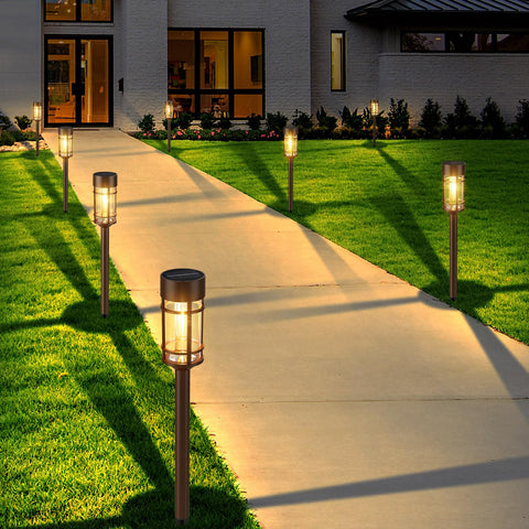 Mancra solar light stake with stainless steel pole along a lawn