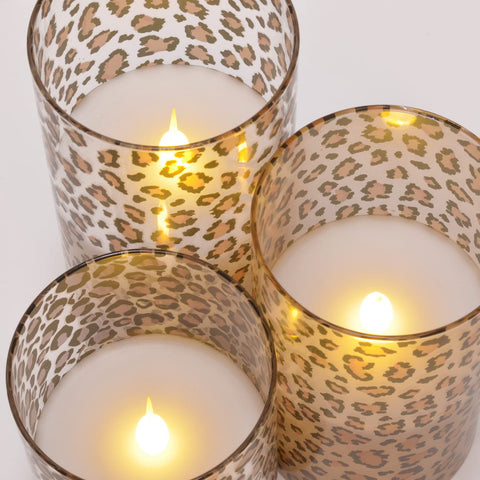 Leopard-print glow from Mark Feldstein & Associates glass pillars enhances shelves without flames.