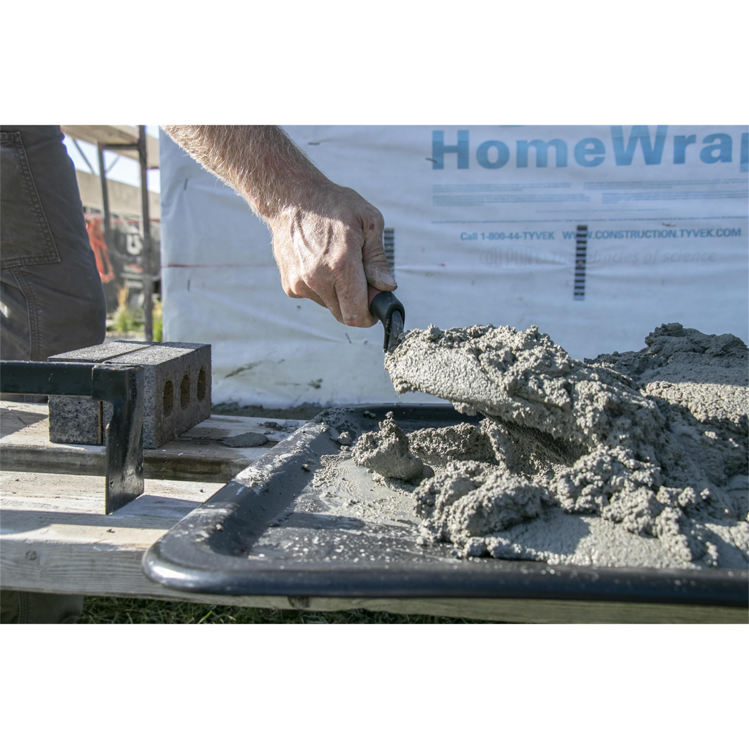 Forged high carbon steel London trowel shown with polished blade for durability.