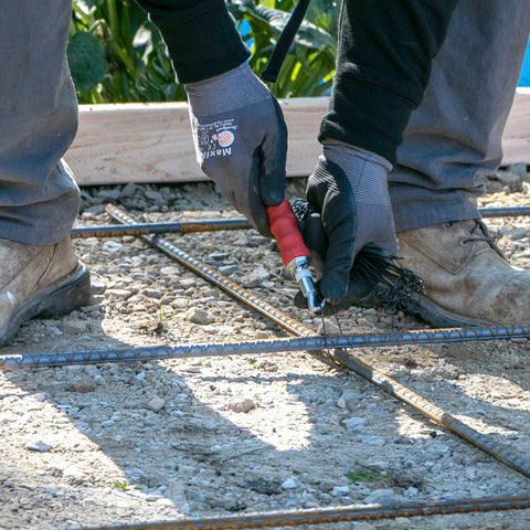 Marshalltown QLT Pull Tie Wire Twister resting in a contractor's toolbox