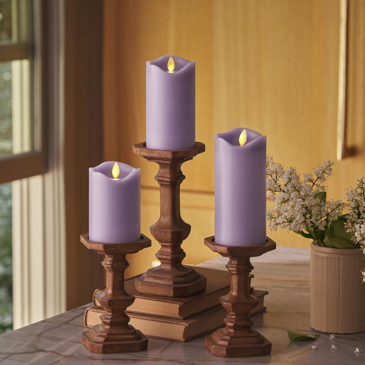 Matchless Candle Co. pastel purple pillar 3-pack side view, cozy indoor ambiance