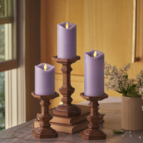 Matchless Candle Co. pastel purple pillar 3-pack side view, cozy indoor ambiance