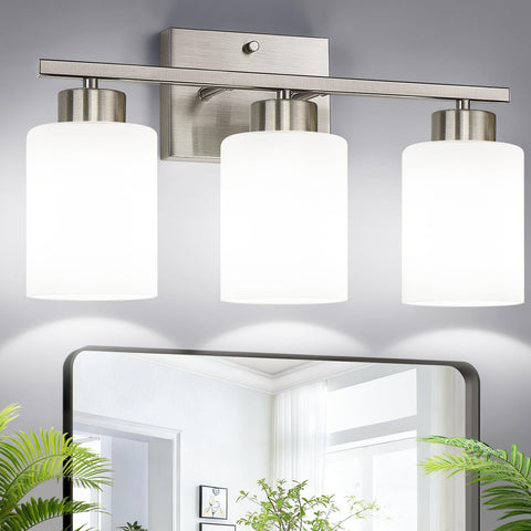 Meybiok brushed nickel three-light vanity fixture with milk glass shades over a bathroom mirror.