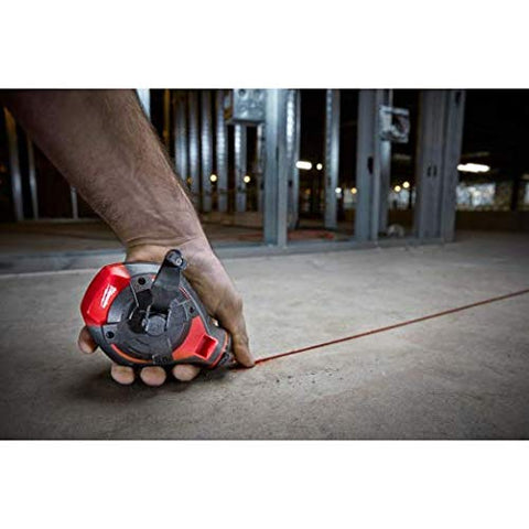 Chalk line being drawn on wood with Milwaukee reel