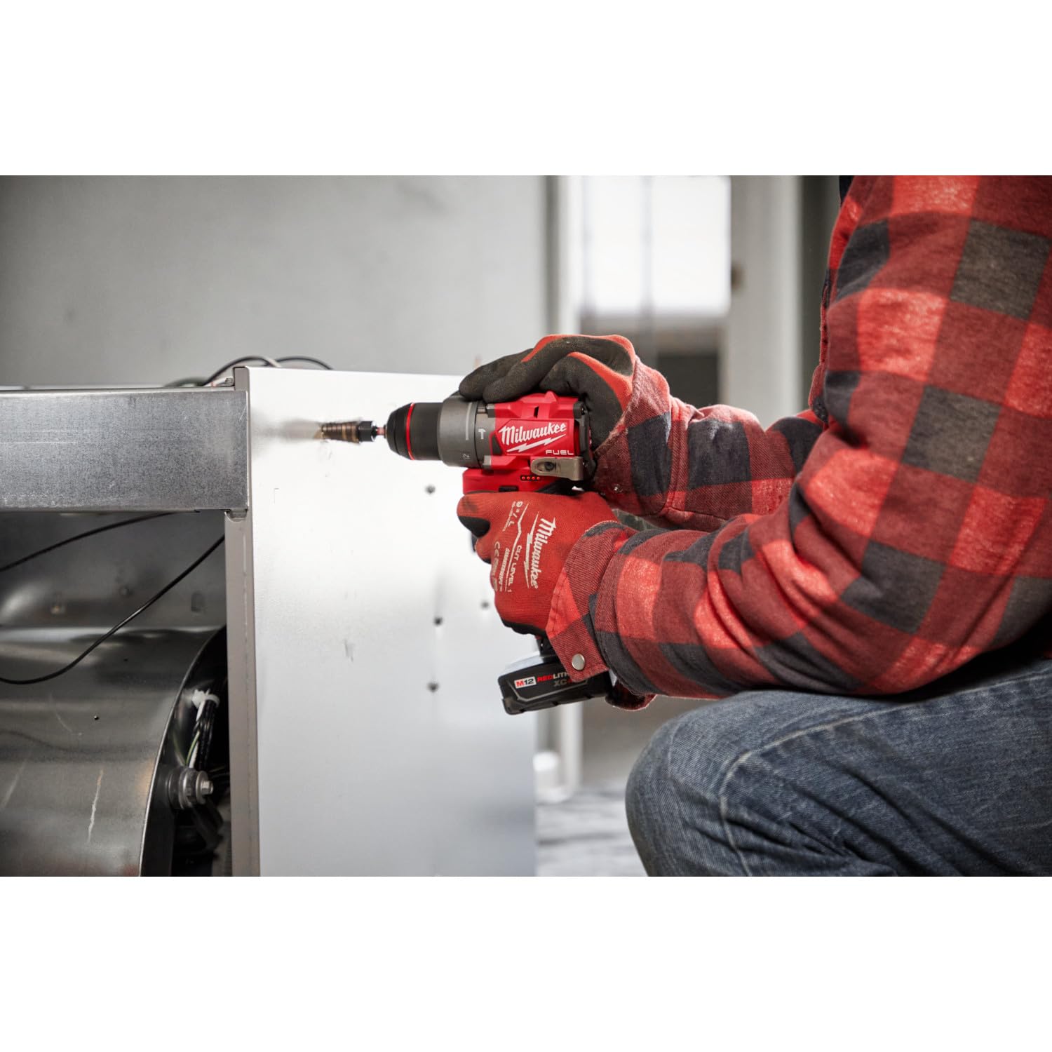 Milwaukee M12 FUEL in-use screw driving scene illustrating fast assembly.