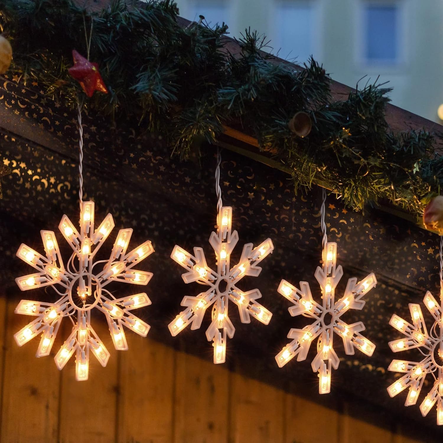 Minetom snowflake lights add festive charm to windows and trees.
