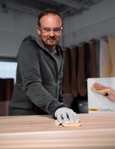 Dry sanding on wood with Mirka Goldflex pad.