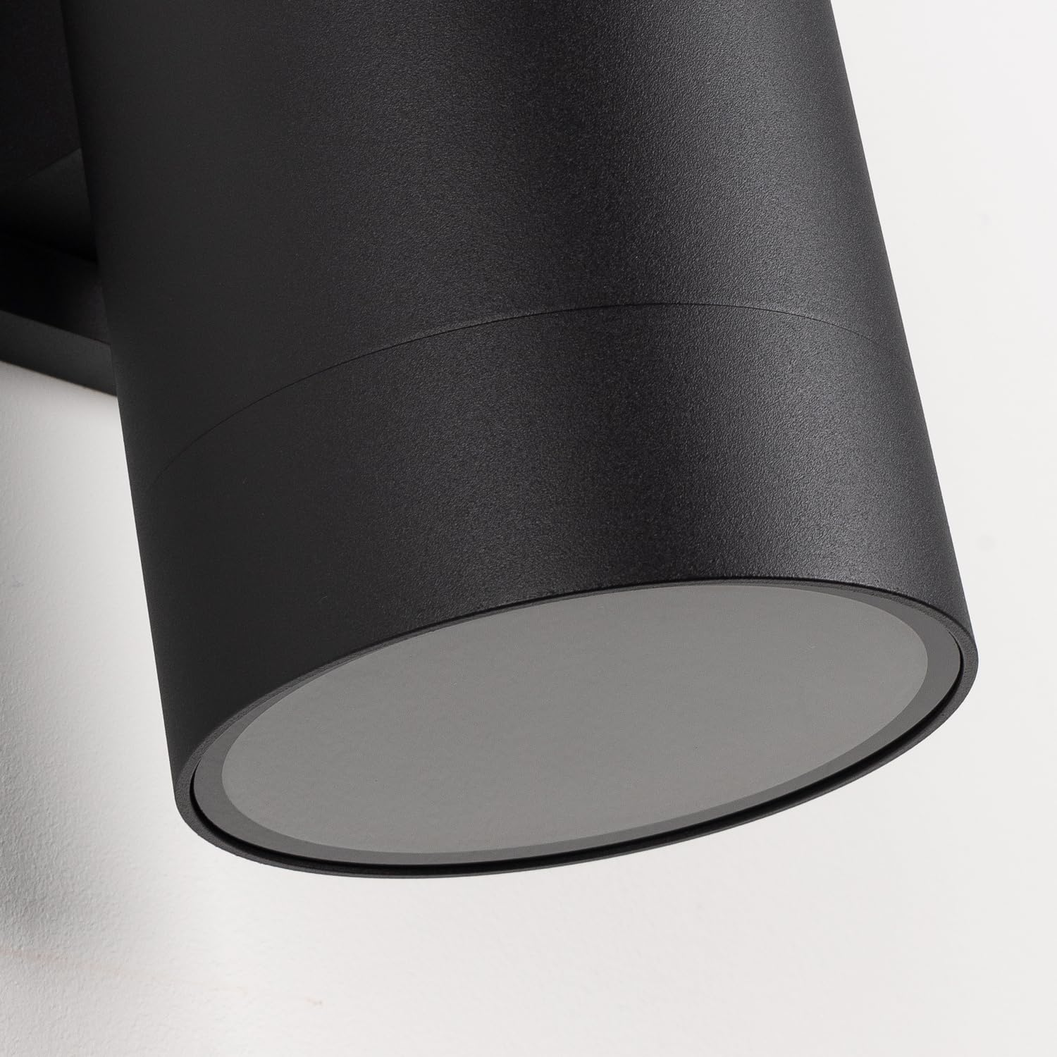 Matte black finish on Mirrea wall light enhances modern exterior design.