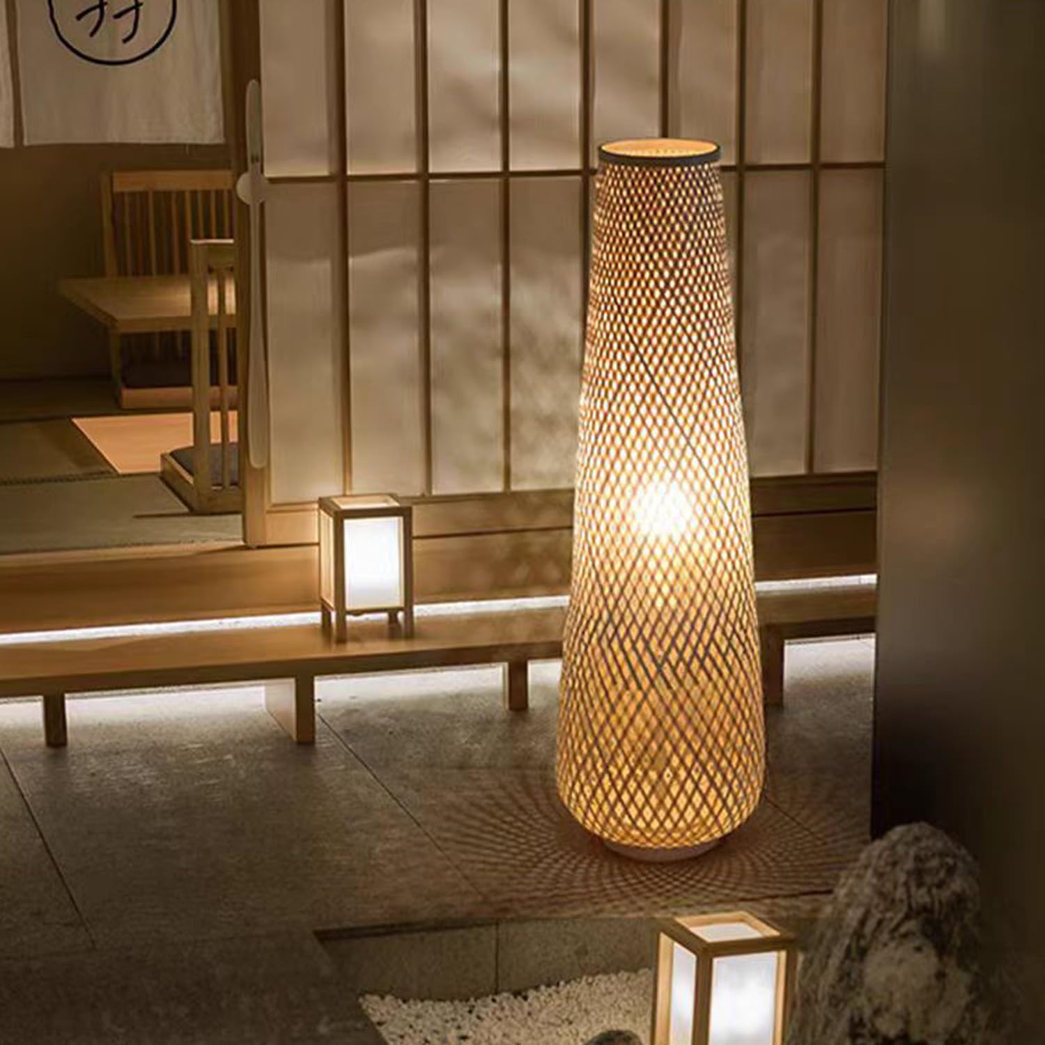 MIXL floor lamp casts soft shadows through bamboo, enhancing depth.