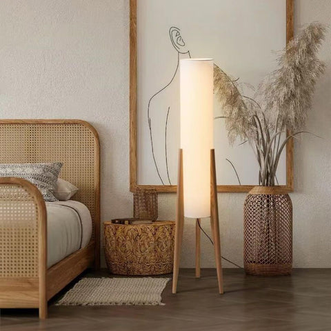 MIXL tripod wooden base floor lamp for warm ambient lighting in living spaces.