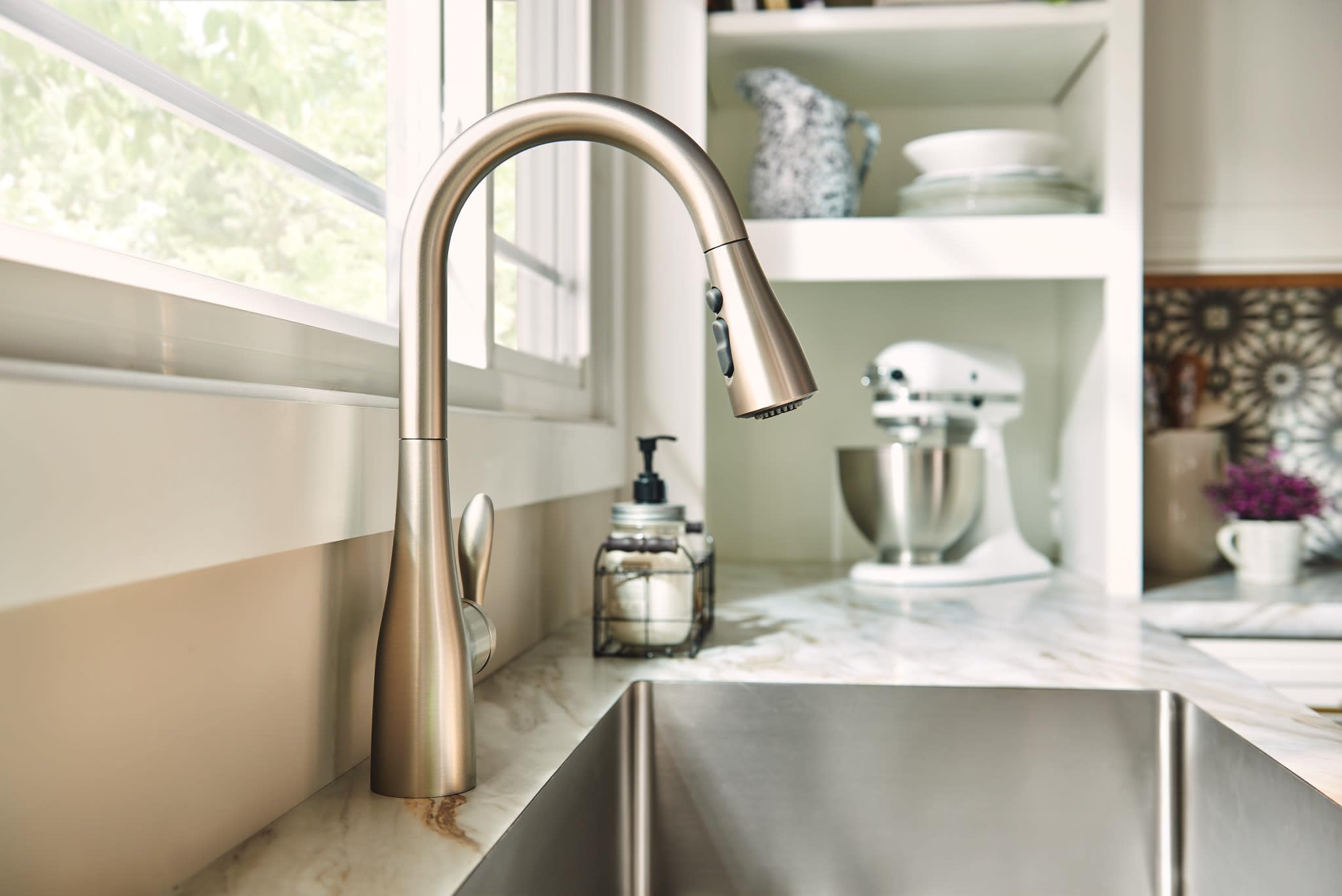 Moen Arbor spout curve adds transitional style to kitchen decor.
