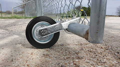 MOFEEZ gate wheel attached to a metal swing gate for smooth movement on concrete.