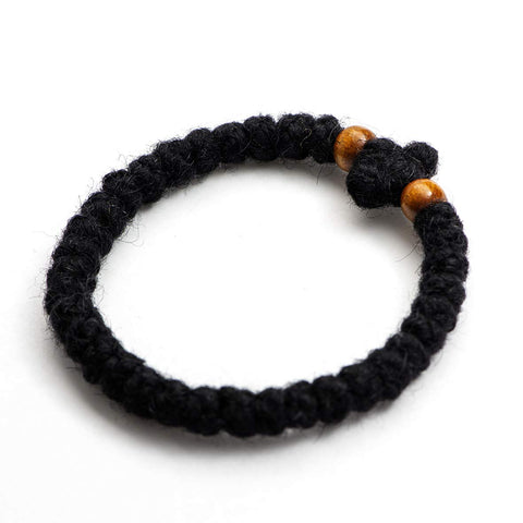 Monastery Vodoca wooden beads detail highlights traditional craft and tactile focus during prayer.