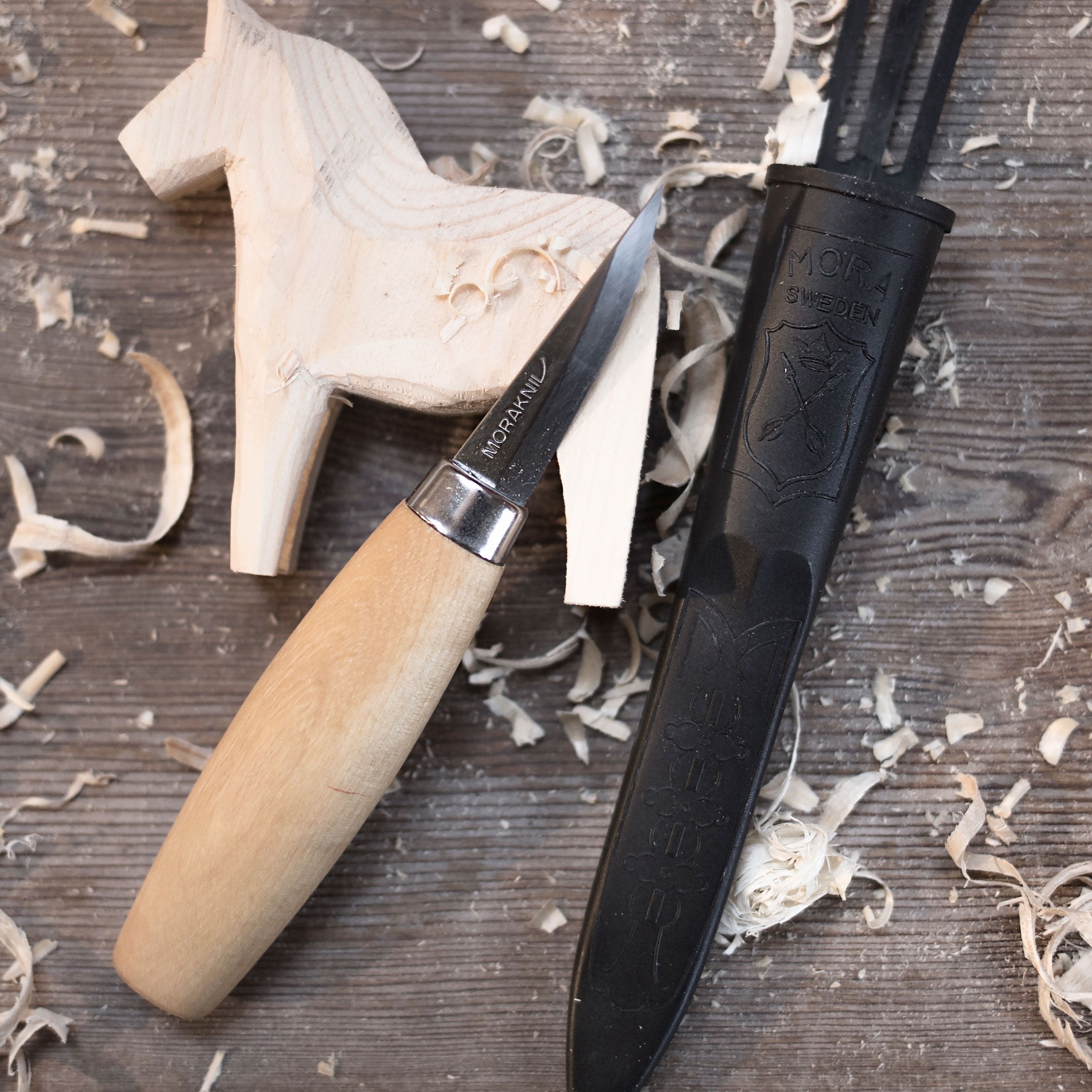 Morakniv Wood Carving Knife 120 in use, carving delicate details with steady control.