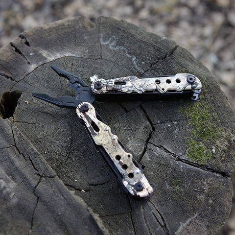 Mossy Oak multitool camo finish on display blending with outdoor gear.