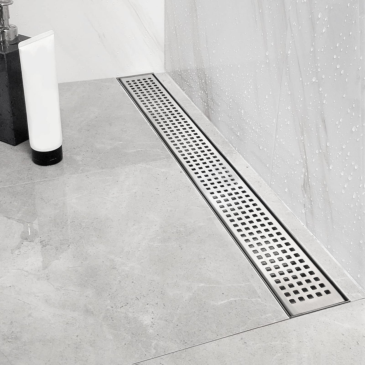 Neodrain Quadrato grate close-up in brushed stainless for a modern bathroom.