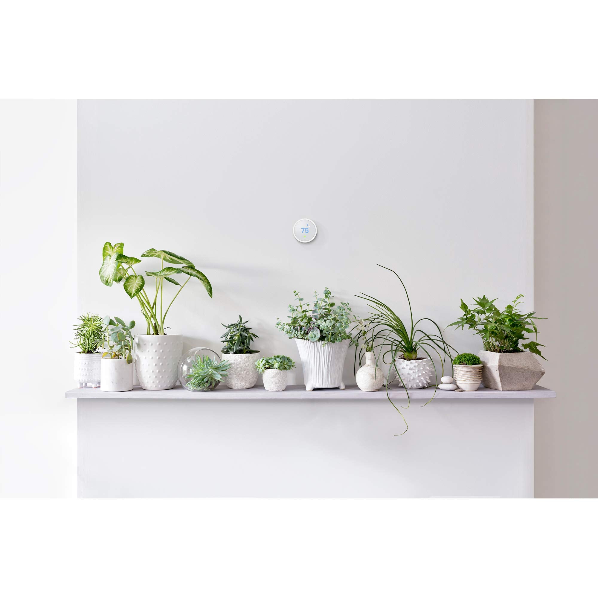 Nest Thermostat E display with energy-saving Leaf indicator.