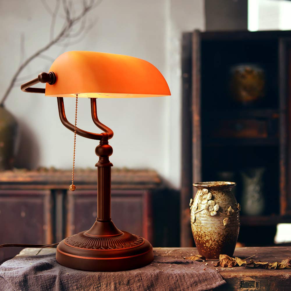 Newrays matted orange glass bankers lamp enhances desk setup with warm, vintage-inspired glow.