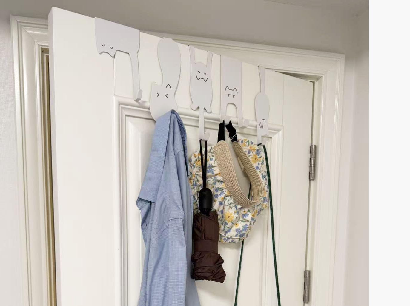 Nooboochichy wall-mounted cat hooks keep clothes and accessories within reach.