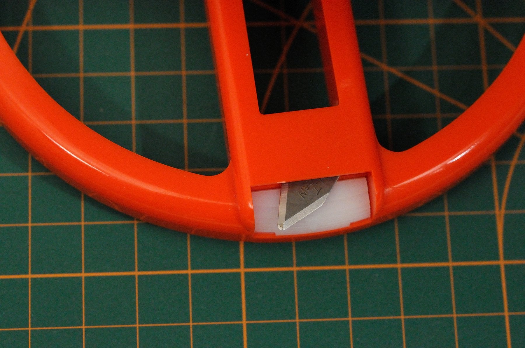 NT Cutter cutting a hole in carpet for installation.