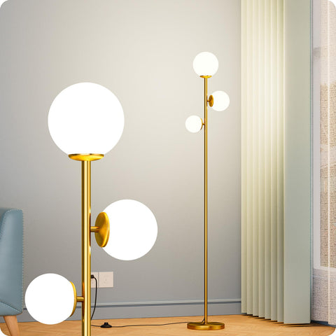 Nukanu floor lamp with three frosted glass shades in a gold finish for warm ambient lighting