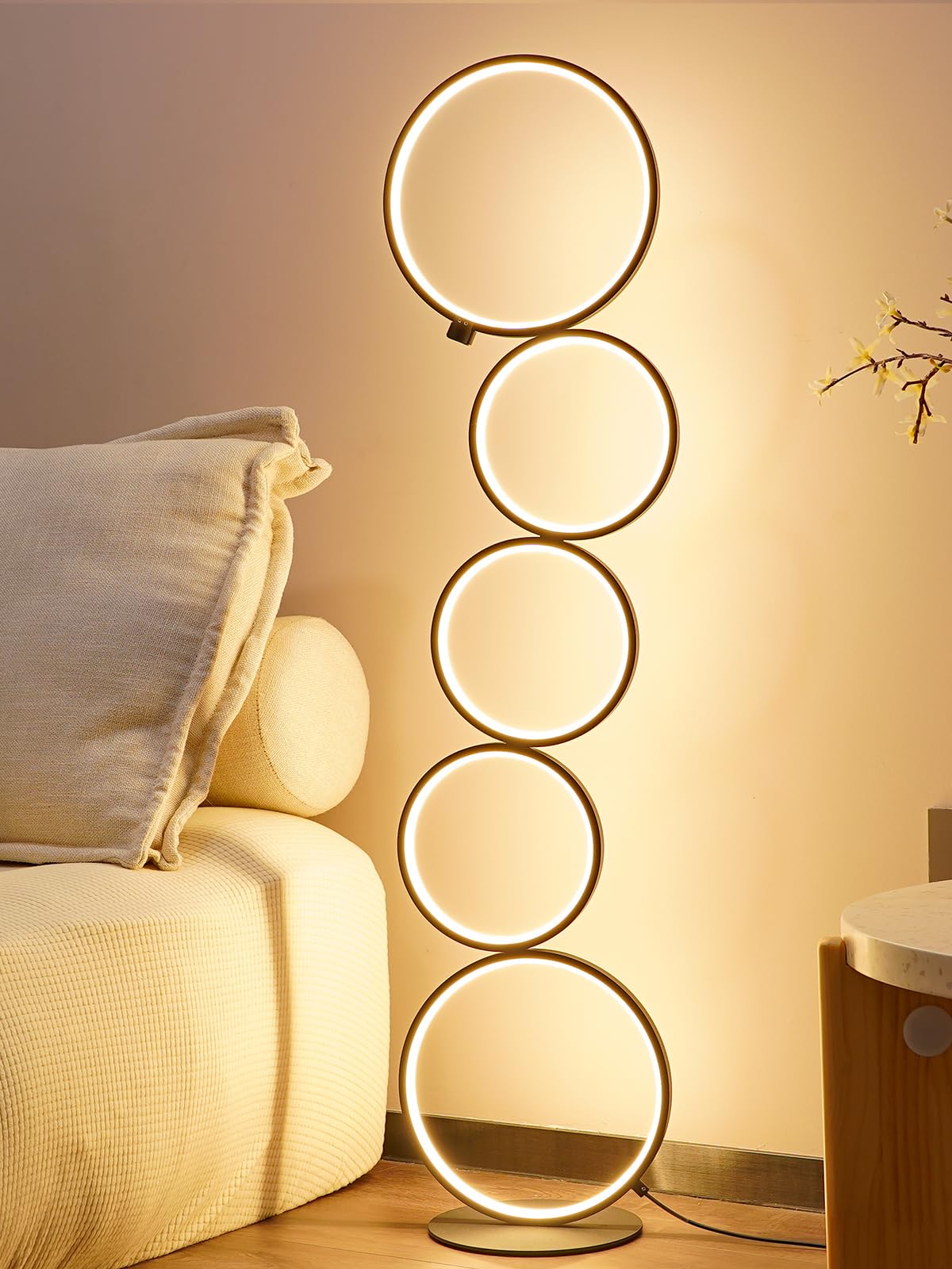 NUÜR Modern 5-Ring LED Floor Lamp with nesting circle enhances a living room centerpiece.