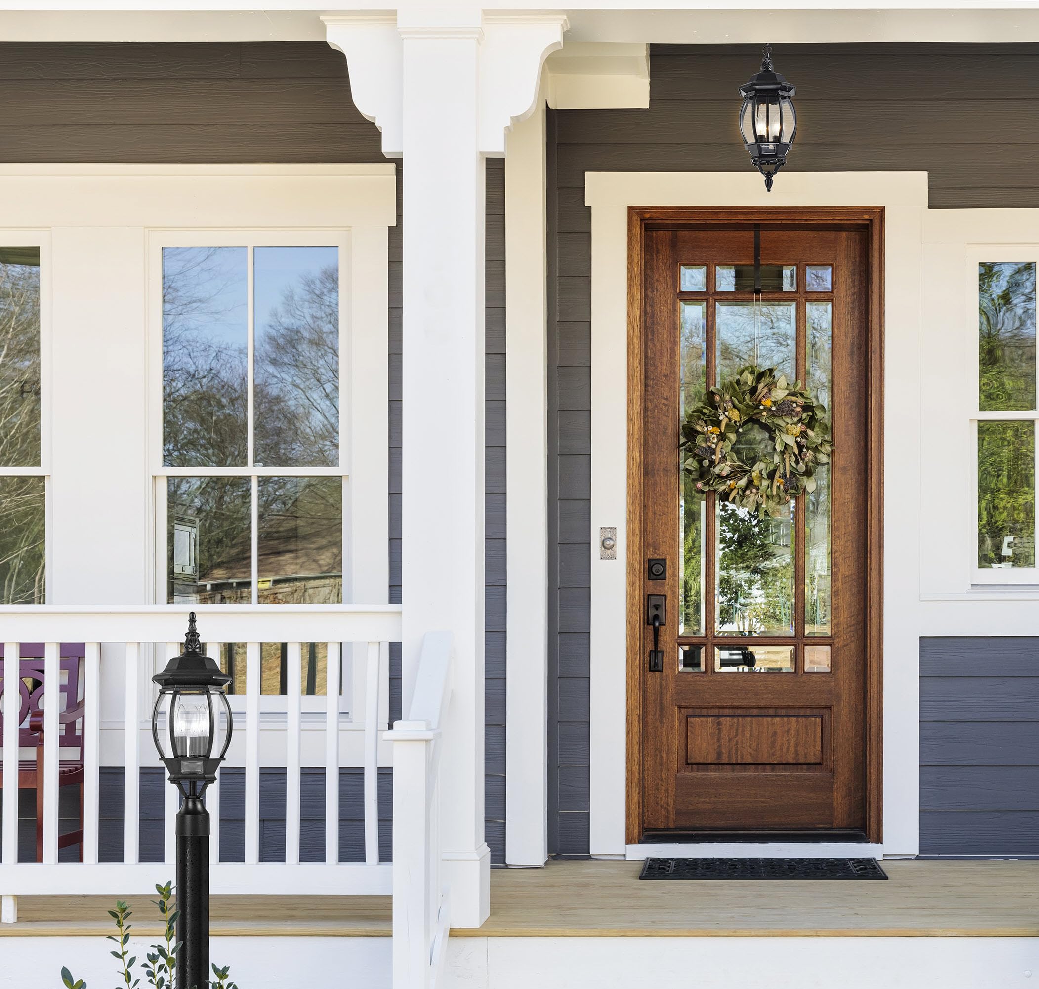 Nuvo 3-light post lantern with clear beveled glass, side view highlights symmetry.