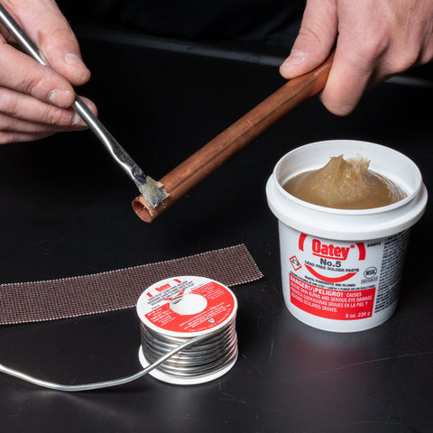 Oatey Safe-Flo brush for even flux application on plumbing joints.