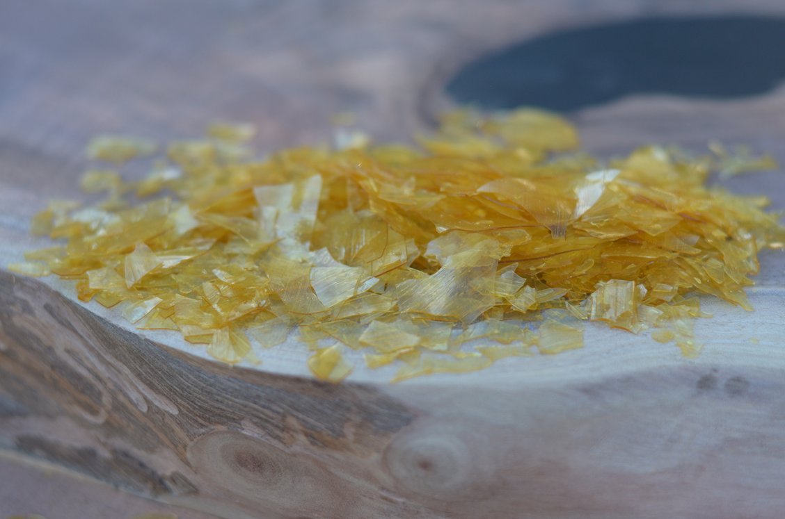 Closeup of de-waxed super blonde shellac flakes showing texture and quality for finishing
