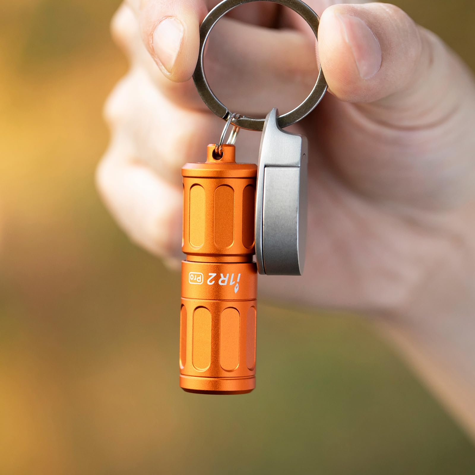 OLIGHT I1R 2 Pro EOS 0.78-ounce weight on a keychain.