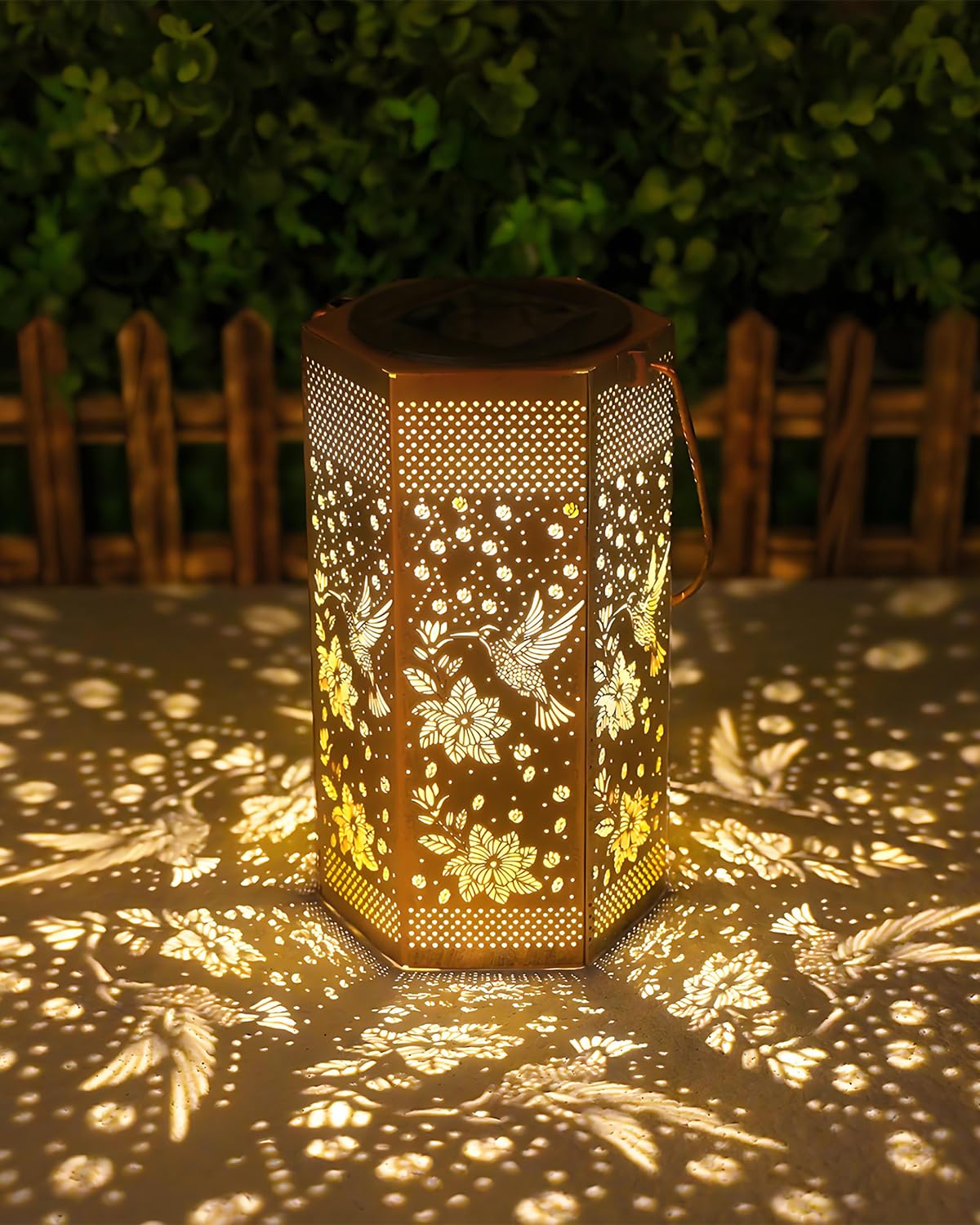 Opjoy hummingbird solar lantern glows in the garden, adding warm ambiance