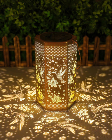 Opjoy hummingbird solar lantern glows in the garden, adding warm ambiance
