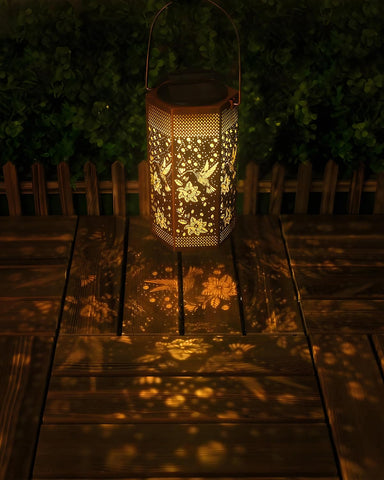 Opjoy hummingbird solar lantern hangs from a tree, adding charm