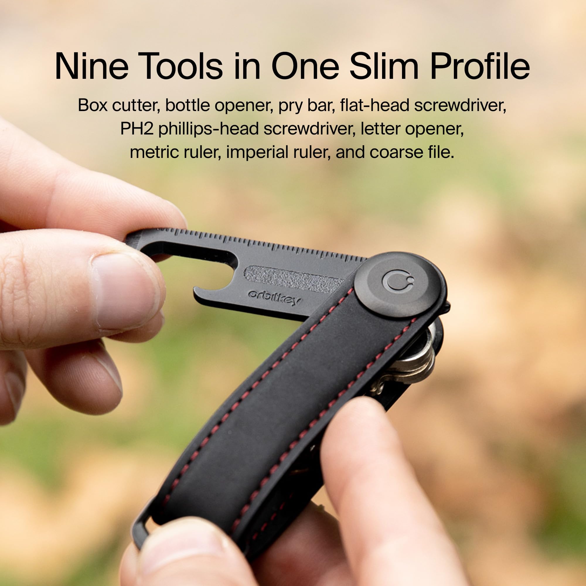 Orbitkey Multi-Tool V2 silver bottle opener in action