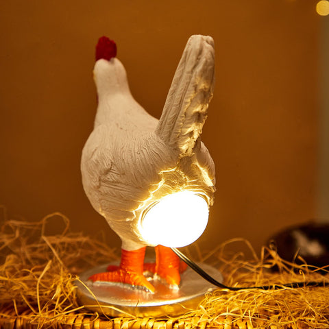Oriamde lamp in bronze on desk with warm glow for reading light