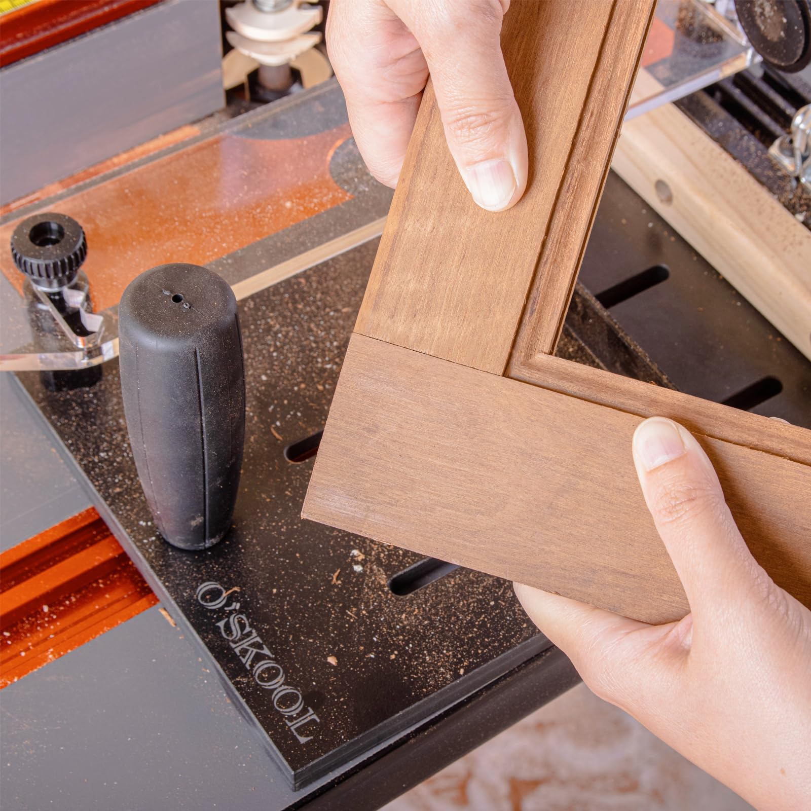 O'SKOOL Retaining bracket keeps workpiece from shifting during cuts.