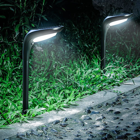 OSORD solar pathway light with ground stake illuminating a garden path at dusk