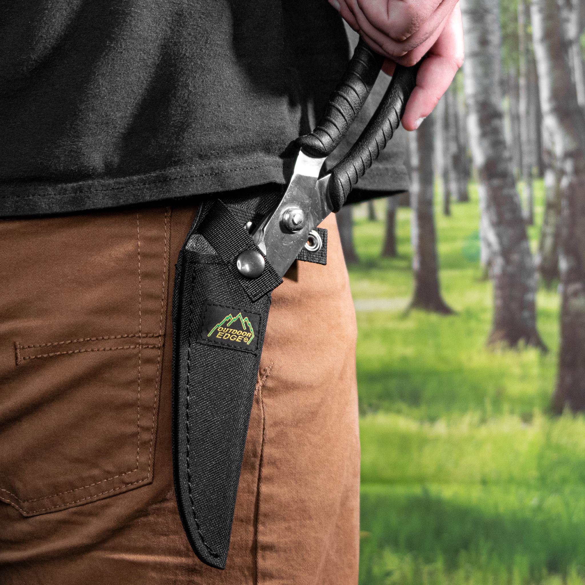 Outdoor Edge Game Shears nylon sheath protects blades and gear during field use.