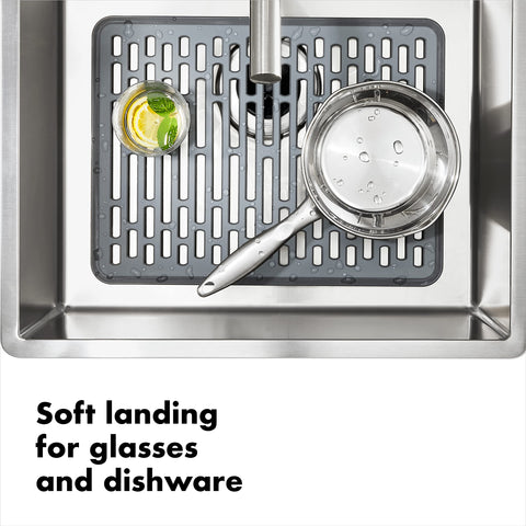OXO Good Grips silicone sink mat large drain-pattern close-up demonstrates cut-hole design.