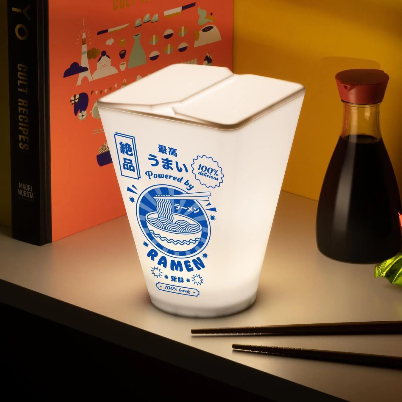 Paladone Ramen Box Light on a bedside table creates cozy reading ambiance