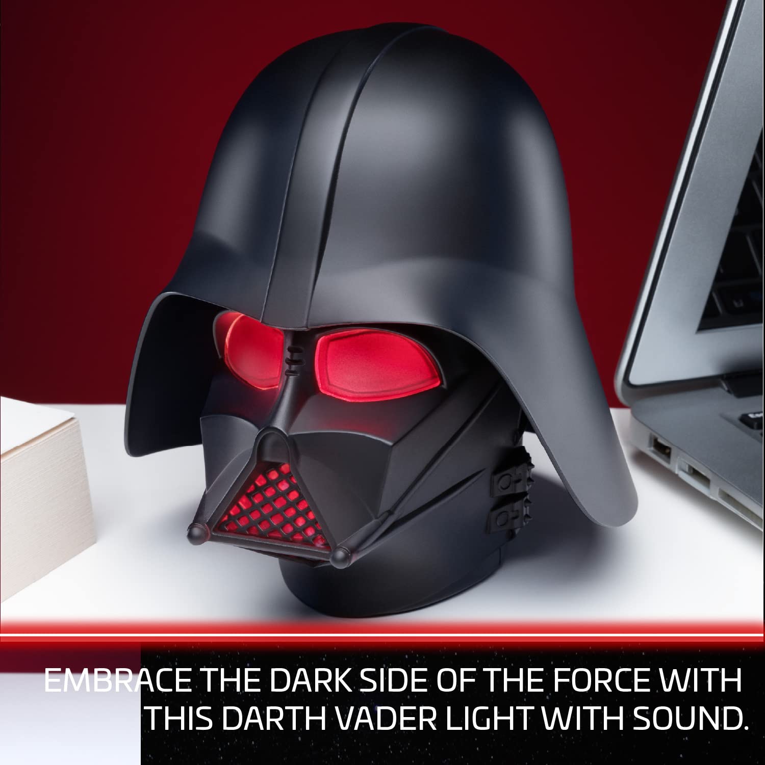 Paladone Darth Vader helmet light on desk creates collectible display piece.