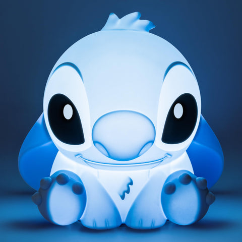 Paladone Stitch squishy lamp lit in a dim room, gentle glow for late-night reading