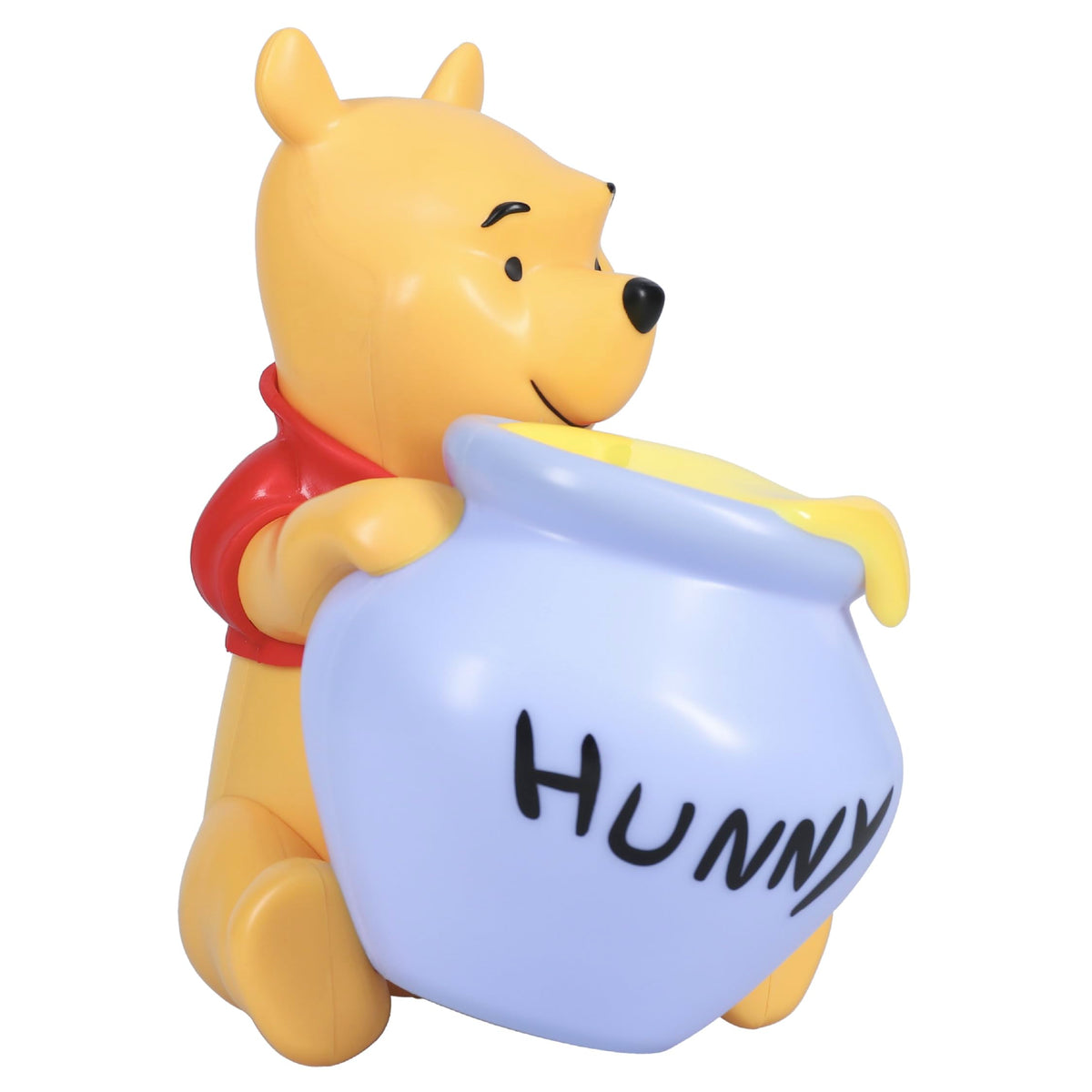 Paladone Winnie the Pooh Hunny Light glows softly on a bedside table for bedtime comfort.