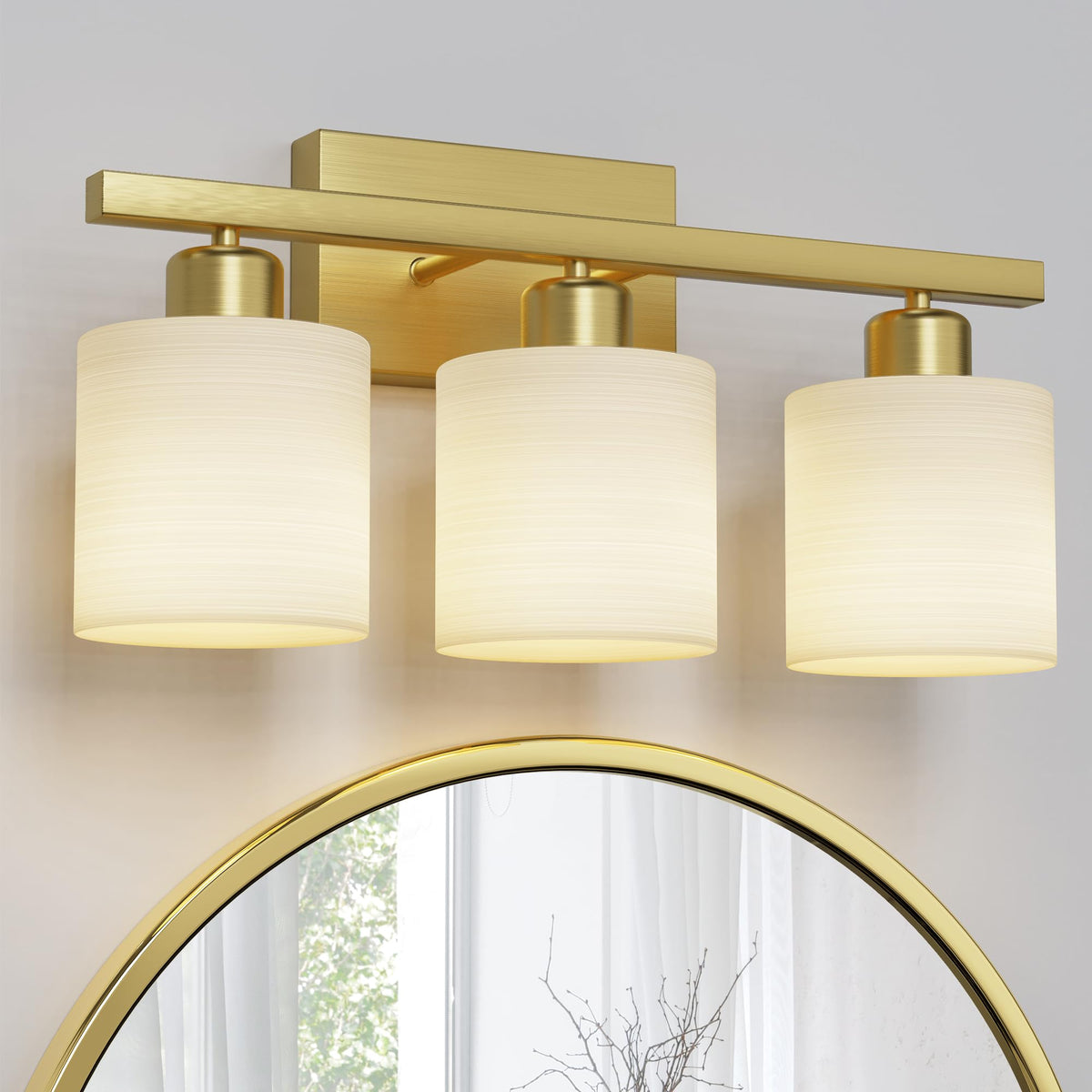 PARTPHONER 3-light brushed-gold vanity light with textured white shade enhances bath ambiance.