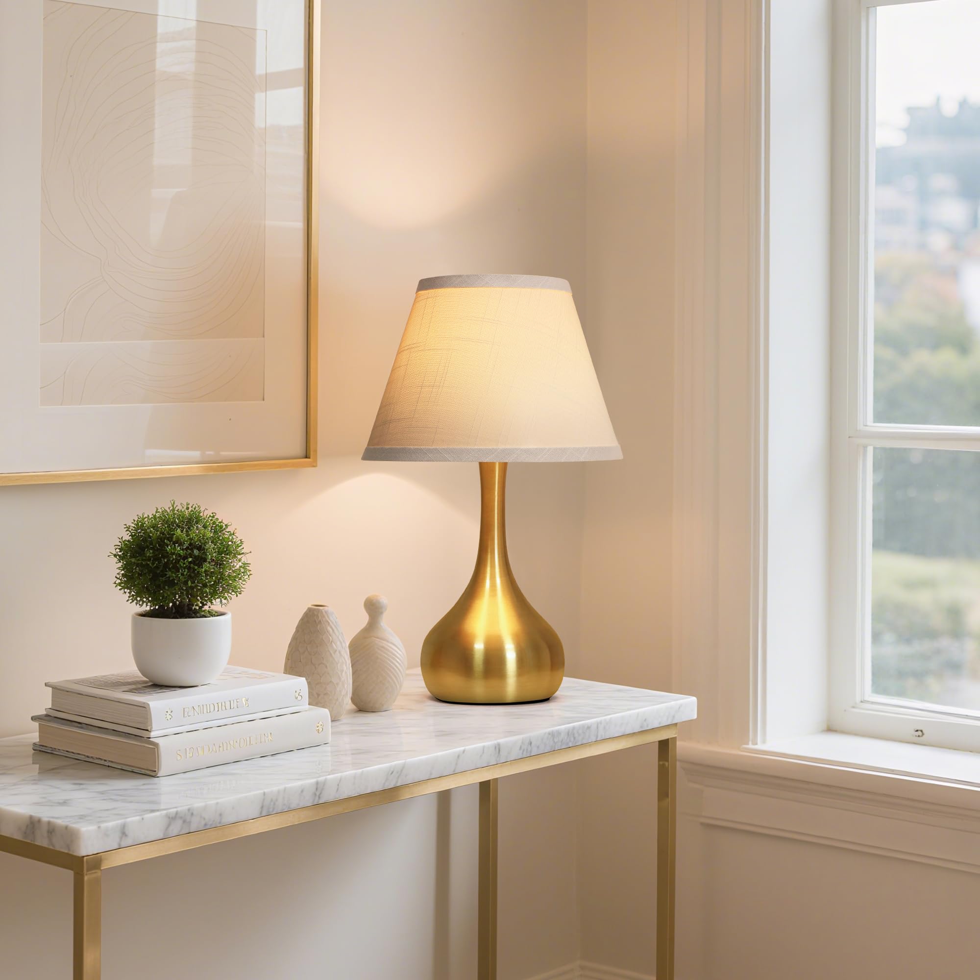 PARTPHONER teardrop-gold base lamp adds a contemporary accent.