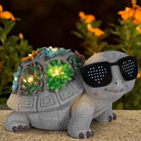 Pawatee solar garden turtle statue with succulent and rotating LED lights enhances outdoor charm.